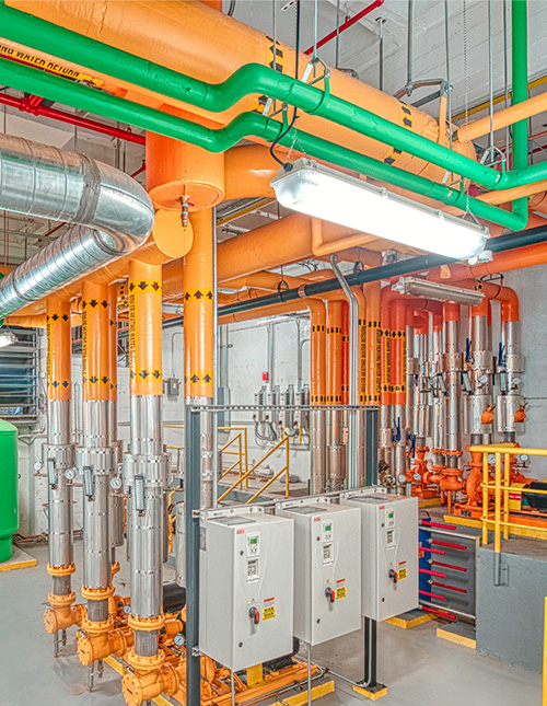 orange and green pipes from an industrial HVAC system