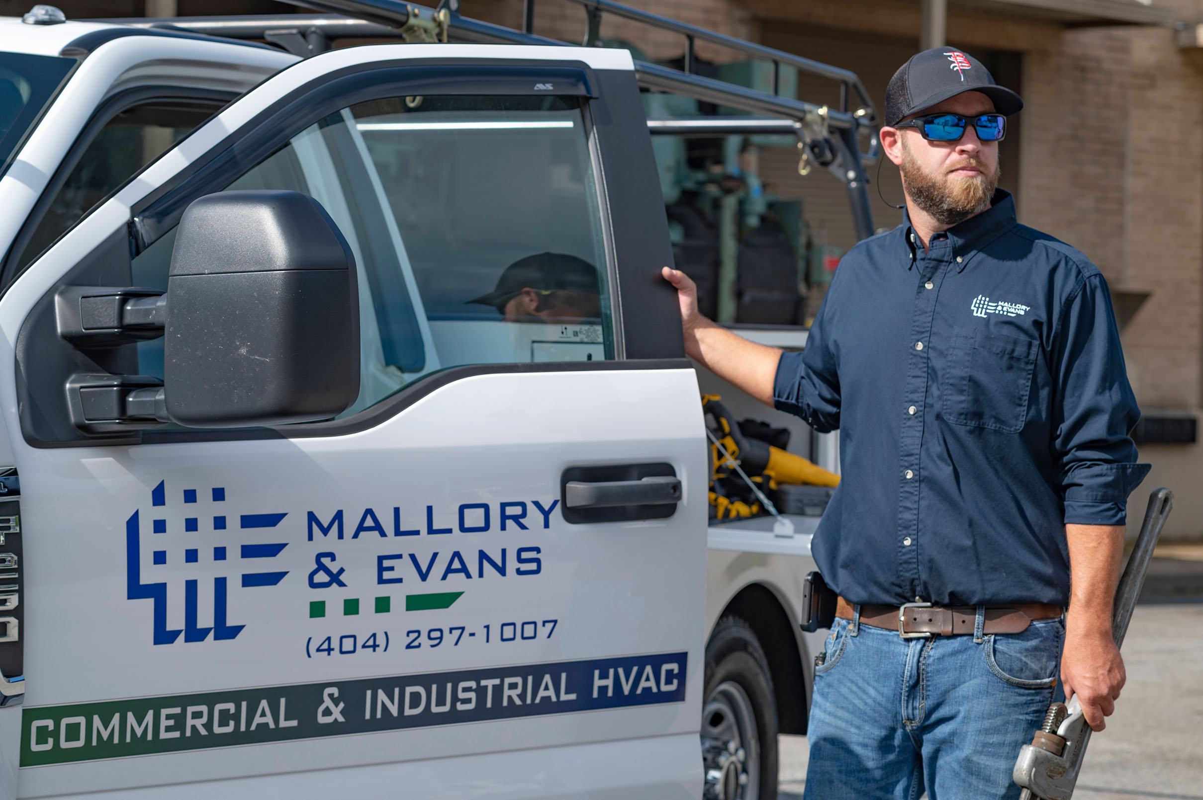A Mallory and Evans retrofit technician with his work truck