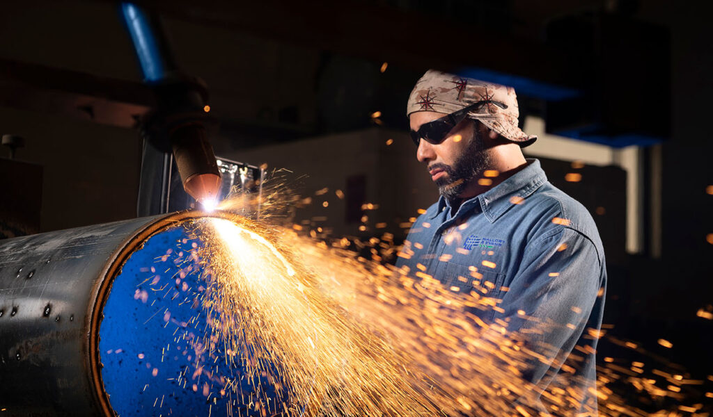 Worker using a plasma torch